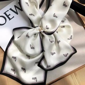 Silk scarf available in white and caramel